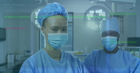 Two surgeons analyzing healthcare data in operating room with floating code 스톡 동영상 307465972