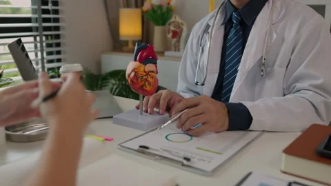 Two surgeons are sitting in their office discussing an upcoming major heart surg Stock Footage 296747800