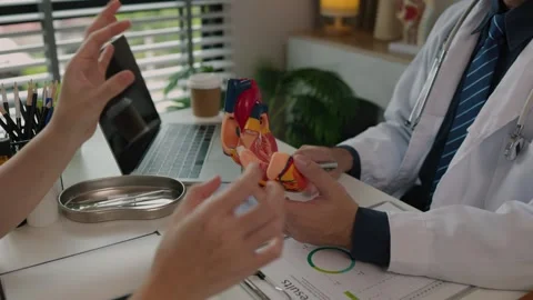 Two surgeons are sitting in their office discussing an upcoming major heart surg Stock Footage 296747870