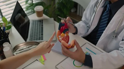 Two surgeons are sitting in their office discussing an upcoming major heart surg Stock Footage 296747889