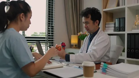 Two surgeons are sitting in their office discussing an upcoming major heart surg Stock Footage 296747975