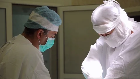 Two surgeons conduct an oncological operation using the newest medical surgical Stock Footage 94021865
