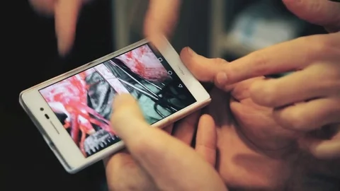 Two surgeons discussing heart surgery looking at the smartphone. Stock Footage 83237802