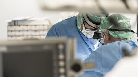 Two surgeons in the operating room during surgery Stock Photos