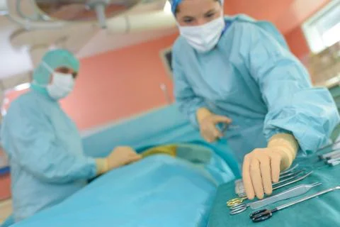 Two surgeons in operating room Stock Photos