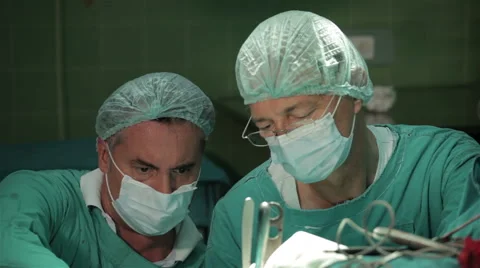 Two surgeons performing hard operation in hospital operating room, face close up Video stock 50989872
