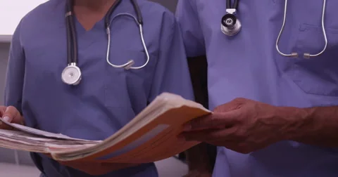 Two surgeons reviewing paperwork in the office 库存影片 59036558