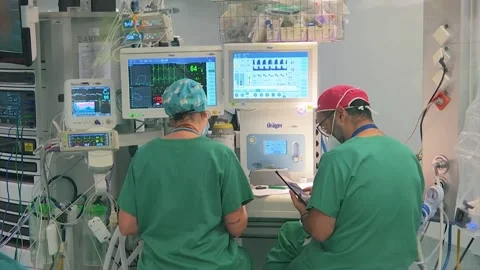 TWO SURGICAL DOCTORS WORKING WITH MACHINES Stock Footage 201741631