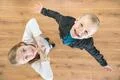 The two surprised children look up. View from above Photo