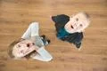 The two surprised children look up. View from above Photo