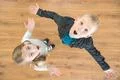 The two surprised children look up. View from above Photo