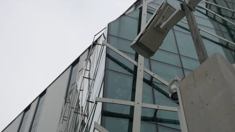 Two surveillance cameras in front of a modern office building Stock Footage 106028307