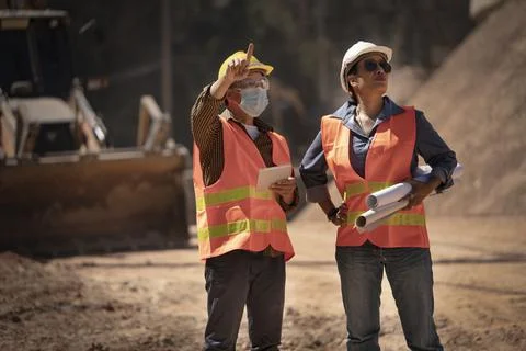 Two Surveyor builder Engineer technician  Business Team discuss plan at new c Stock Photos