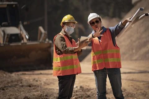 Two Surveyor builder Engineer technician  Business Team discuss plan at new c Stock-Fotos