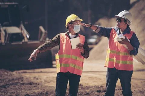 Two Surveyor builder Engineer technician  Business Team discuss plan at new c Stock Photos