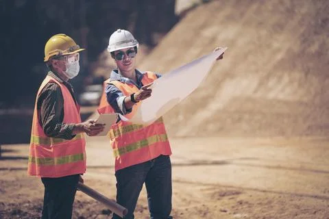 Two Surveyor builder Engineer technician  Business Team discuss plan at new c Stock Photos