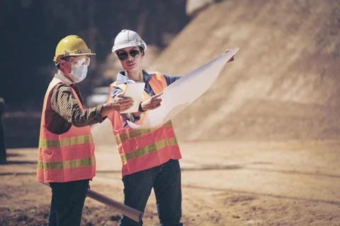 Two Surveyor builder Engineer technician  Business Team discuss plan at new c Stock Photos