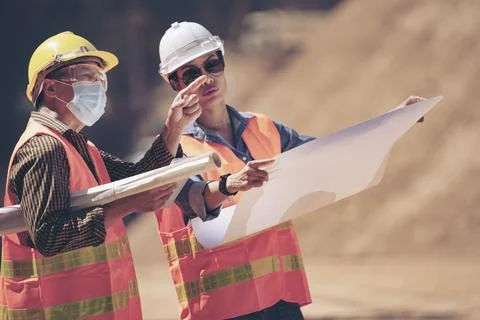 Two Surveyor builder Engineer technician  Business Team discuss plan at new c Stock-Fotos