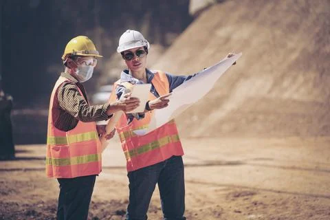 Two Surveyor builder Engineer technician  Business Team discuss plan at new c Stock Photos