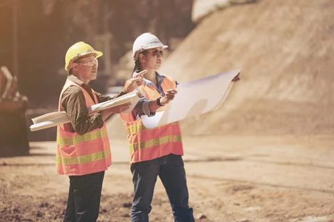 Two Surveyor builder Engineer technician  Business Team discuss plan at new c Stock-Fotos