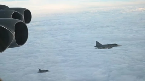 Two Swedish Air Force JAS 39 Gripen aircraft flying with U.S.A.F. B-52 Bomber Stock Footage 294191592