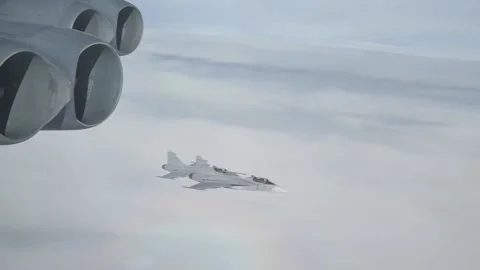 Two Swedish Air Force Saab JAS 39 Gripen aircraft flying with of B-52 Bomber Vídeos de archivo 213580414