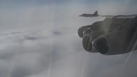 Two Swedish Air Force Saab JAS 39 Gripen aircraft fly with U.S. Air Force B-52 Stock Footage 213580455