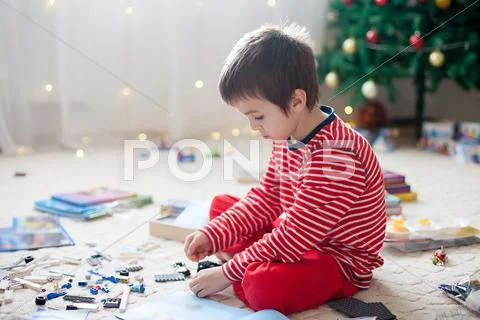 Two sweet boys, opening presents on Christmas day Stock Photos