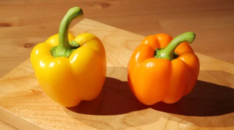 Two sweet peppers on a board Stock Footage 53285321