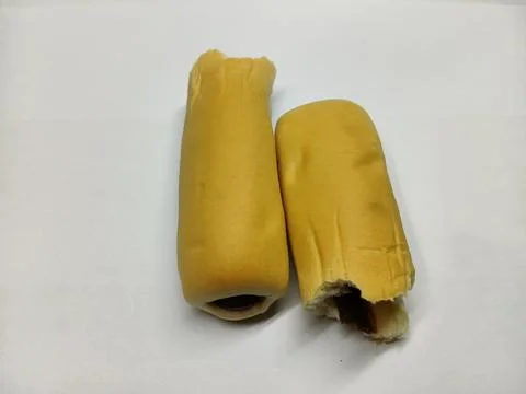 Two sweet soft bread rolls filled with chocolate cream on a white background Stock Photos