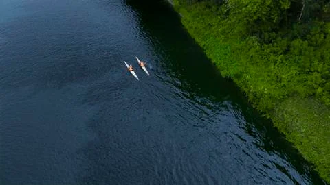 Two swimmers floating down the river the view from the drone Stock Photos