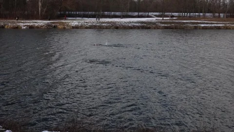 Two swimmers training in icy river Stock Footage 329632117