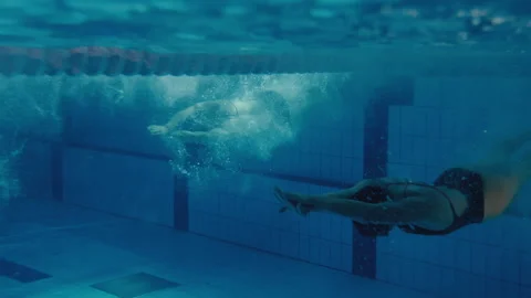 Two swimmers training in a swimming pool Stock Footage 275621664