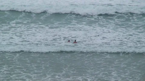 Two Swimmers Wading into Waves of Ocean Video stock 35561719