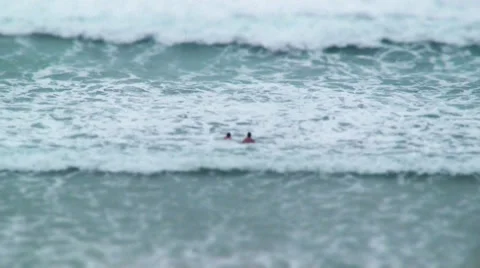 Two Swimmers Wading into Waves of Ocean Video stock 35561943