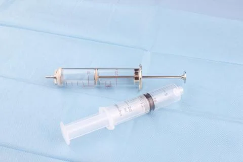 Two syringe on blue background Stock Photos
