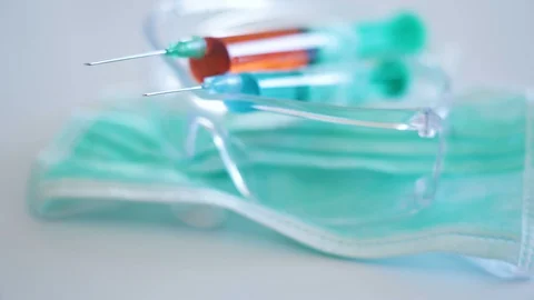 Two syringe on top of the transparent eye glasses Stock Footage 129463728