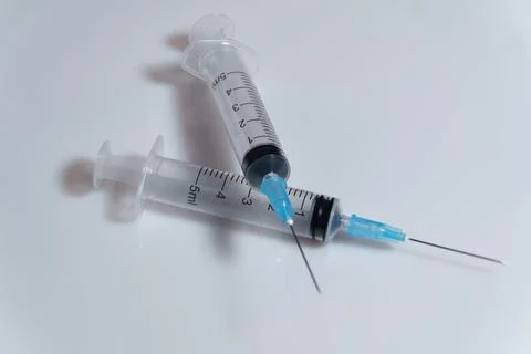 Two syringes on the white background Stock Photos