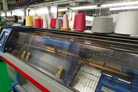 Two system industrial textil flat knitting machine during working process Stock Photos
