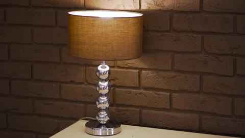 Two table lamps and a mirror on the background of a brick wall. Stylish interior Stock Footage 171293914