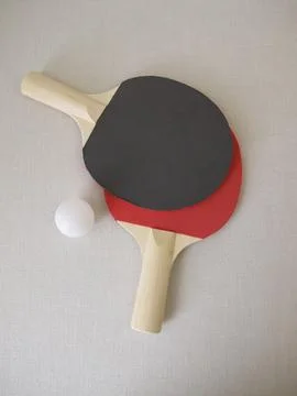 Two table tennis rackets and a tennis ball Stock Photos