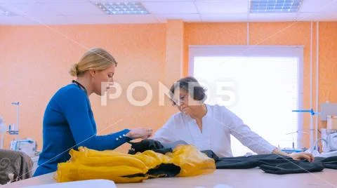 Two tailors discussing new couture collection Stock Photos