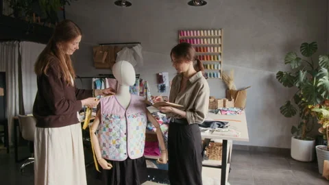 Two Tailors Taking Measures of Patchwork Vest Sample on Mannequin Video stock 315769281