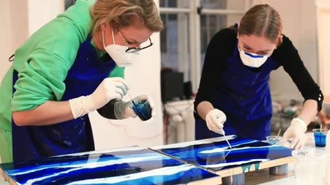 Two talented artists make an epoxy painting with dye in workshop Video stock 145158579