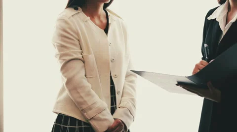 Two talking businesspeople with document Stock Footage 58582966