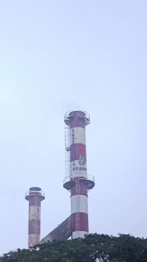 Two Tall Red And White Industrial Smokestacks Of A Sugar Factory In Mist Stock Footage 340199411