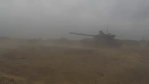 Two tanks stand in the middle of the field and fire in turn. Stock Footage 314094292