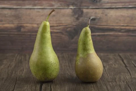 Two tasty fresh pears placed on wooden surface Stock Photos