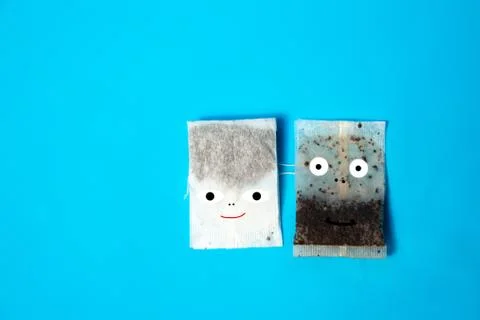 Two tea bags look at the camera On a blue background Stock Photos