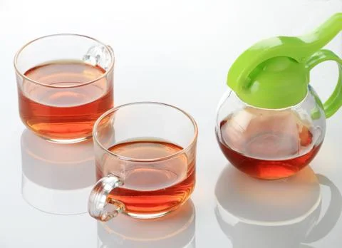 Two Tea Cup and Kettle in white reflective background Stock Photos